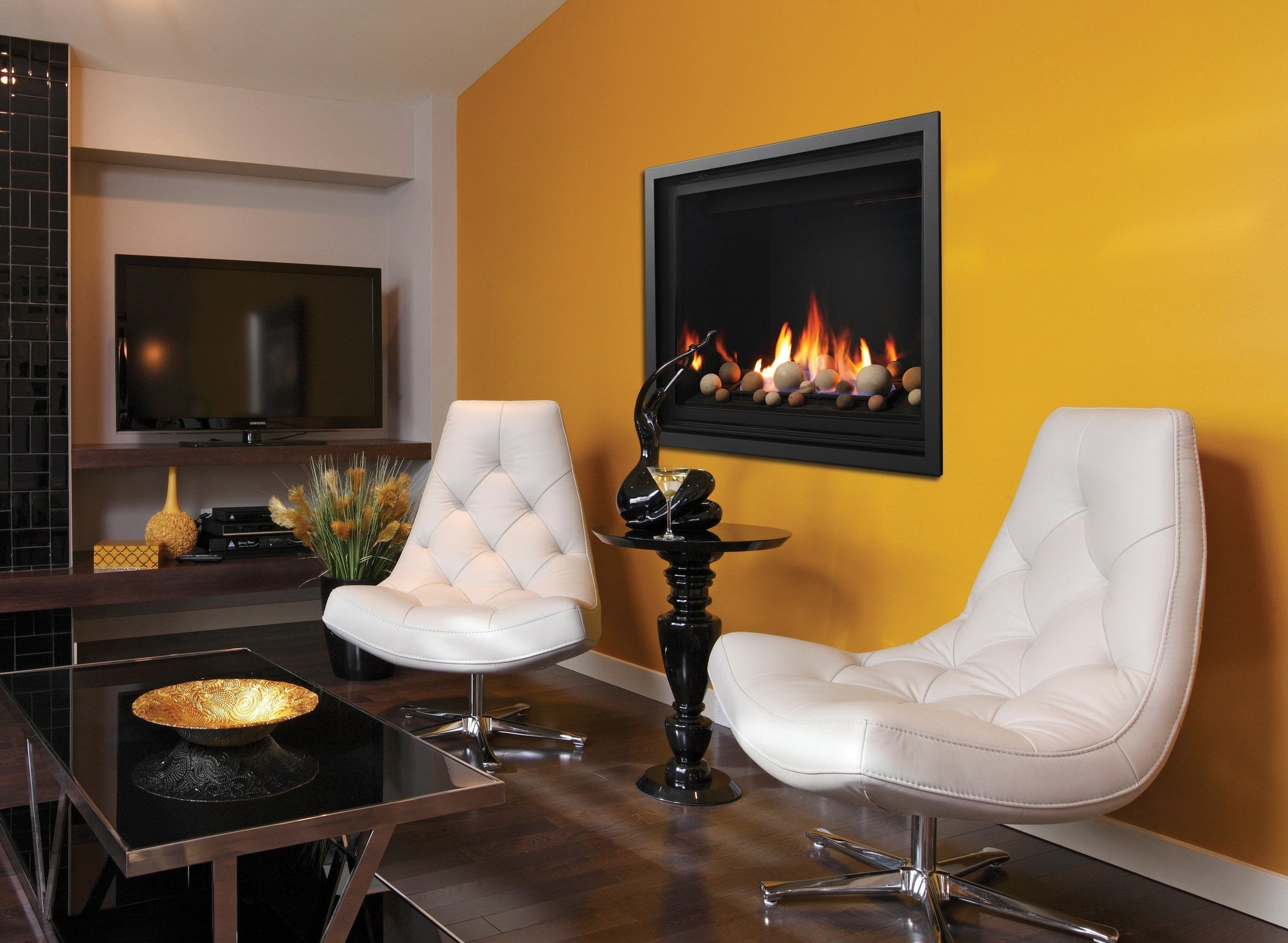 Kingsman Bentley zero clearance direct vent gas fireplace with multi-coloured cannonballs on the glass tray, wall-mounted in a contemporary sitting room
