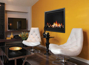 Kingsman Bentley zero clearance direct vent gas fireplace with multi-coloured cannonballs on the glass tray, wall-mounted in a contemporary sitting room