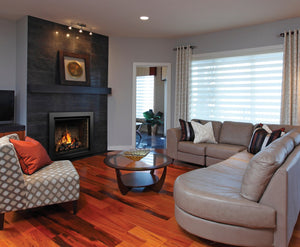 Kingsman Bentley zero clearance direct vent gas fireplace with five-piece log set and traditional refractory brick liner, installed in a slate-tiled living room